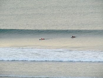 People on beach against sea