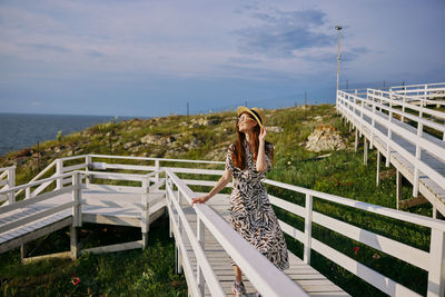 Woman standing on footbridge