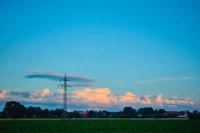 Scenic view of field against blue sky