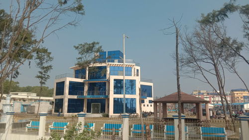 Low angle view of buildings against clear blue sky