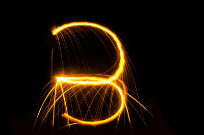 Number 3 light painting against black background