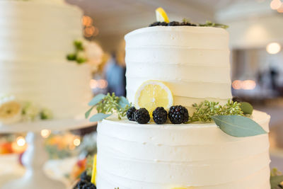 Close-up of wedding cake on stand at table