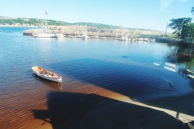 High angle view of boats moored at shore against sky