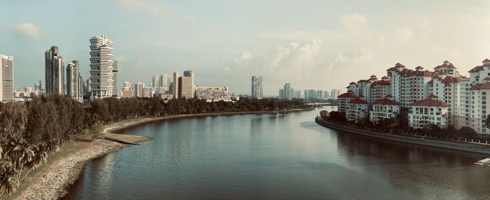 Panoramic view of river and buildings against sky