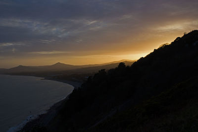 Scenic view of silhouette mountains against sky during sunset