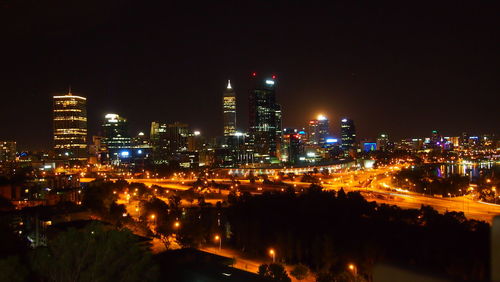 High angle view of illuminated buildings against clear sky at night