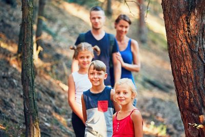 Portrait of family standing in forest