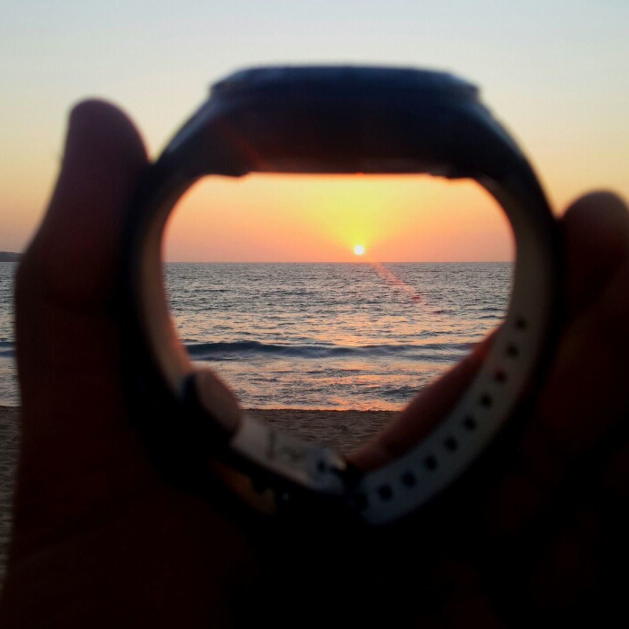 sea, sunset, horizon over water, water, beach, reflection, sky, leisure activity, lifestyles, part of, scenics, cropped, silhouette, sun, beauty in nature, tranquil scene, holding