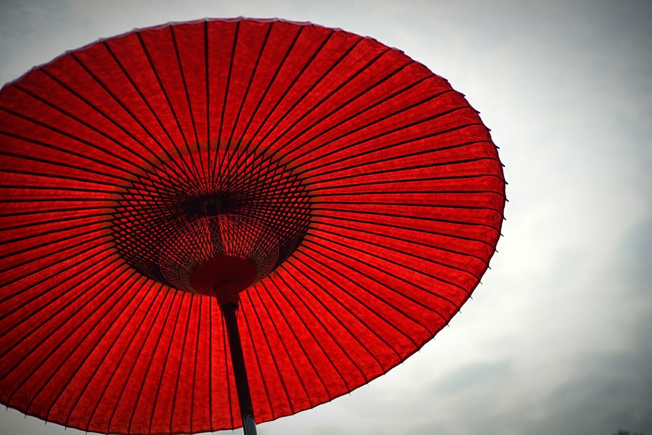 low angle view, sky, red, circle, pattern, geometric shape, no people, ferris wheel, day, outdoors, cloud - sky, shape, arts culture and entertainment, protection, design, metal, directly below, amusement park, nature, orange color