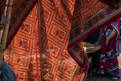 Full frame shot  of woman framed by hanging sari