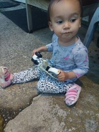 Portrait of cute girl sitting outdoors