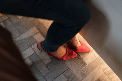 Low section of woman standing on tiled floor