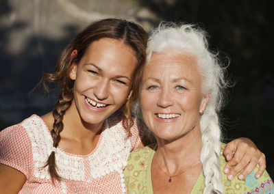 Portrait of adult daughter and mother in garden