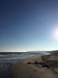 Scenic view of beach against clear sky