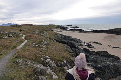 Rear view of woman looking at sea against sky