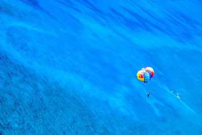 High angle view of person parasailing over sea