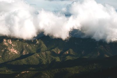 Scenic view of mountains against cloudy sky