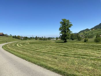 Scenic view of land against clear blue sky