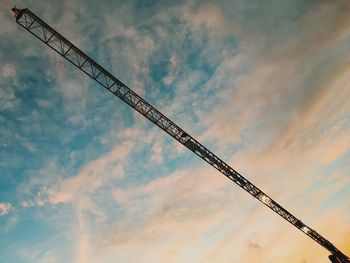 Low angle view of crane against sky