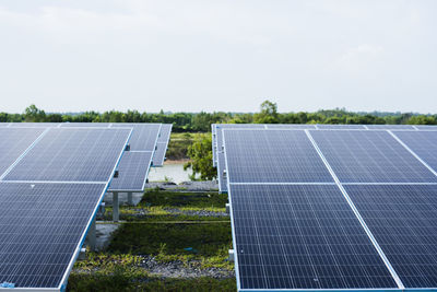 Solar panels on field against clear sky