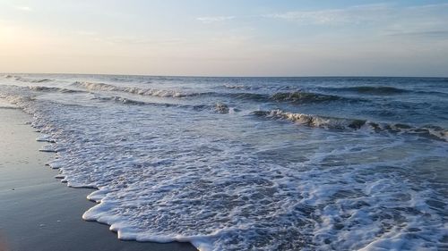 Ocean waves rolling in on the sand.