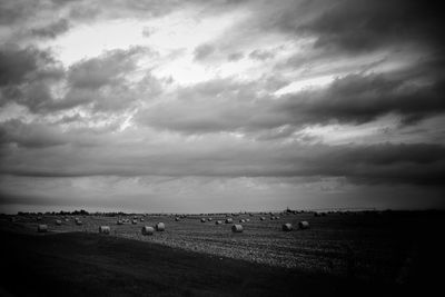 Scenic view of field against cloudy sky