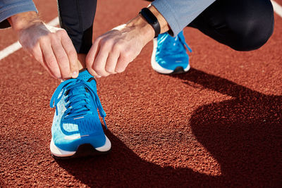 Runner get ready for run, tying sneakers shoelaces