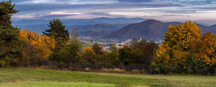 Scenic view of trees and mountains against sky during autumn