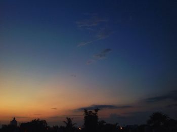 Low angle view of silhouette trees against sky at sunset