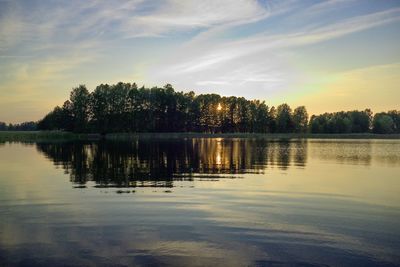 Scenic view of lake against sky at sunset