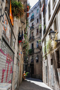 Narrow barcelona street with antique lamppost in the gothic neighborhood of barcelona, spain.