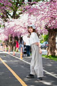 Full length of woman standing on road