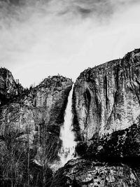 Scenic view of waterfall against sky