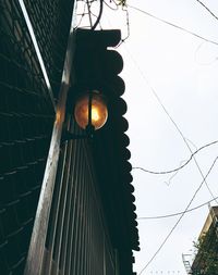 Low angle view of illuminated lamp against sky