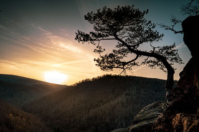 Scenic view of silhouette mountains against sky at sunset