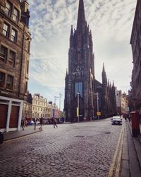 Street amidst buildings against sky in city