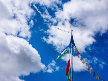 Low angle view of flags on pole against sky