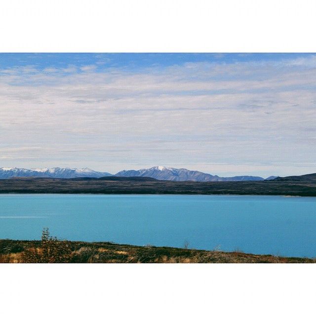 tranquil scene, tranquility, scenics, water, sky, lake, beauty in nature, mountain, transfer print, nature, landscape, auto post production filter, mountain range, cloud - sky, blue, idyllic, cloud, non-urban scene, day, outdoors