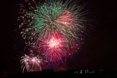 Low angle view of firework display at night