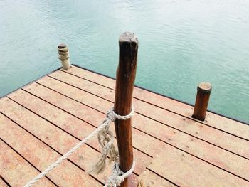 High angle view of wooden post on pier at lake