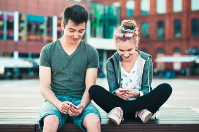 Young couple sitting in city