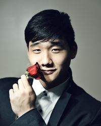 Portrait of young man against gray background