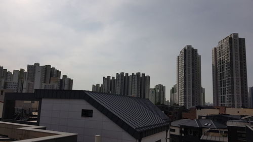 Modern buildings in city against sky