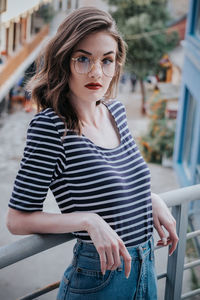 Portrait of young woman standing outdoors