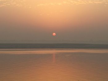 Scenic view of sea against orange sky