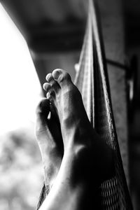 Low section of man relaxing on hammock