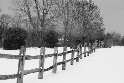 Snow covered cemetery against sky