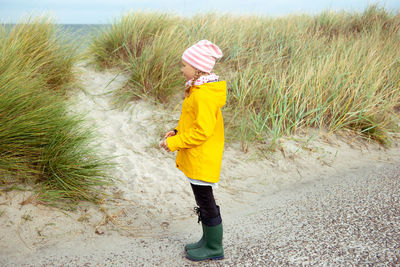 Full length of girl standing at beach