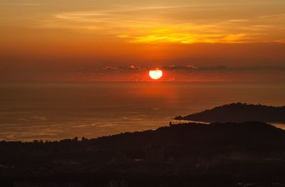 Scenic view of sea against romantic sky at sunset