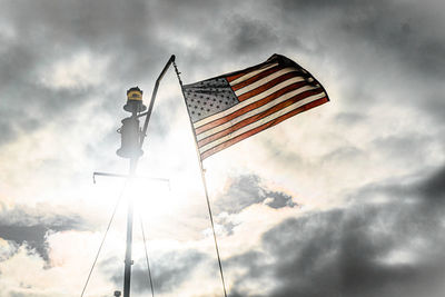 Low angle view of american flag against sky